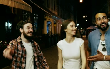 Stock Video Friends Laugh And Walk Down City Street At Night For PC
