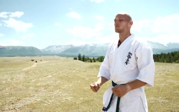 Stock Video Karate Black Belt Meditating In Open Field Landscape Animated Wallpaper