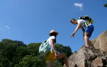 Stock Video Hiking Man Helping His Partner Climb Animated Wallpaper