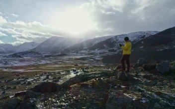 Stock Video Hiker Taking Photos At The Mountains Animated Wallpaper