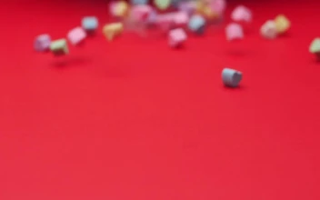 Stock Video Heart Candies Sliding On A Red Surface Animated Wallpaper
