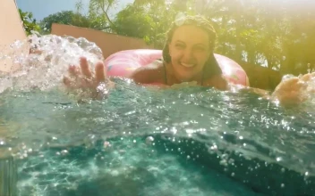 Stock Video Happy Woman Playing With Water In A Swimming Pool Animated Wallpaper