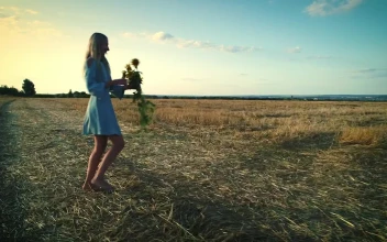 Stock Video Happy Woman In The Field With Sunflowers And A Blue Animated Wallpaper