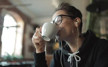 Stock Video Happy Urban Woman Sips Coffee And Listens To Music Animated Wallpaper