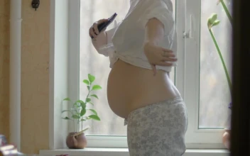 Stock Video Happy Pregnant Woman By The Window Animated Wallpaper