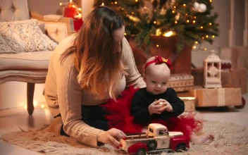 Stock Video Happy Mom With Her Baby On Christmas Night Animated Wallpaper