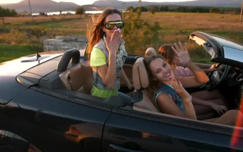 Stock Video Happy Girls Traveling In A Convertible Car At Sunset Animated Wallpaper
