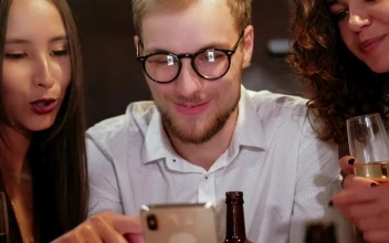 Stock Video Happy Friends Looking At Photo In A Bar Animated Wallpaper