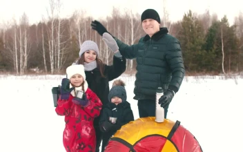 Stock Video Happy Family Waving In A Snowy Forest Animated Wallpaper