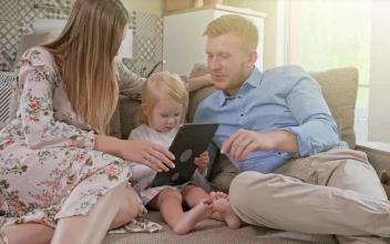 Stock Video Happy Family Laughing While Using A Tablet Animated Wallpaper