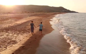 Stock Video Happy Couple Walks Along The Beach At The Seaside Animated Wallpaper