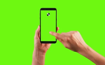 Stock Video Hands Using A Cellphone With Tracking Point On A Green Animated Wallpaper