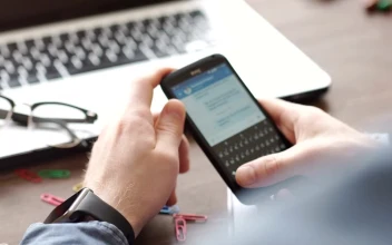 Stock Video Hands Scroll Through Facebook On Mobile At Desk Animated Wallpaper
