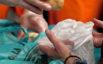Stock Video Hands Of A Volunteer Gives Bread To Hungry People Animated Wallpaper