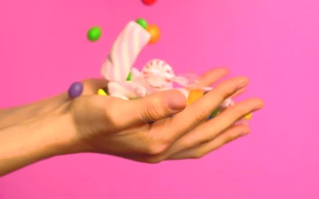 Stock Video Hands Of A Person Full Of Sweets On A Pink Animated Wallpaper