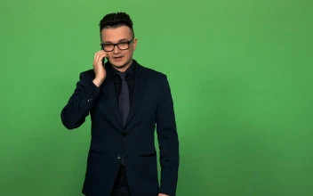 Stock Video Man In Suit And Glasses Answering A Phone Call Animated Wallpaper