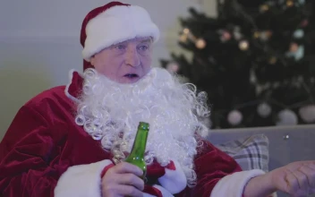 Stock Video Man In Santa Costume Drinks Beer On Sofa Animated Wallpaper