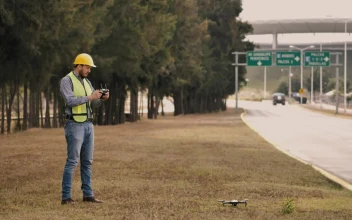 Stock Video Man In Hard Hat Flying Drone On Side Of The Animated Wallpaper