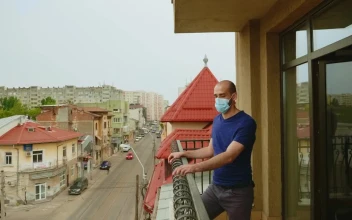 Stock Video Man In Face Mask Thinks About Quarantine On Balcony Animated Wallpaper