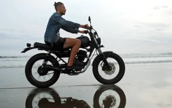 Stock Video Man In Denim Jacket Riding Motorcycle On Beach Animated Wallpaper