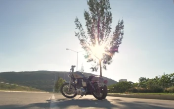 Stock Video Man In Biker Gear Approaches Stationary Motorcycle Animated Wallpaper