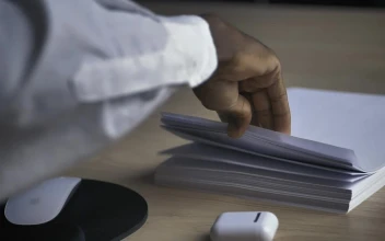 Stock Video Man In An Office Taking A White Sheet Of Paper Animated Wallpaper