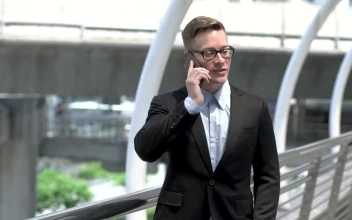 Stock Video Man In A Suit Talking On His Mobile Phone Animated Wallpaper
