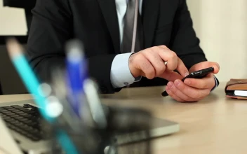Stock Video Man In A Suit In His Office Using His Cellphone Animated Wallpaper