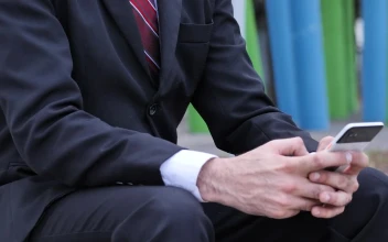 Stock Video Man In A Suit And A Mask Checks His Cell Animated Wallpaper
