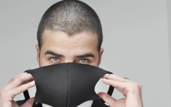 Stock Video Man Facing The Camera While Putting On A Mask Animated Wallpaper