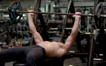 Stock Video Man Exercising With A Dumbbell In A Gym Animated Wallpaper