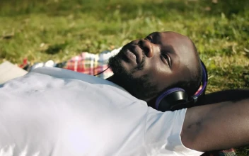 Stock Video Man Enjoying Music In The Park Animated Wallpaper