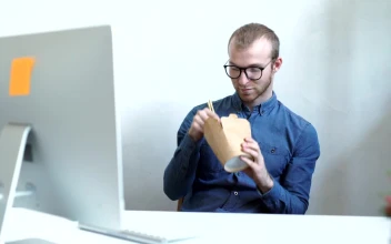 Stock Video Man Eats Chinese Food On Work Break In Office Animated Wallpaper