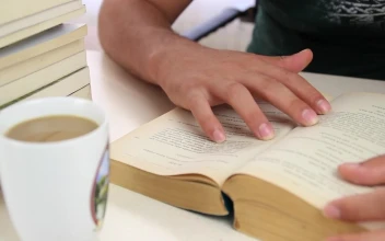 Stock Video Man Drinks Coffee From A Mug While Studying Animated Wallpaper