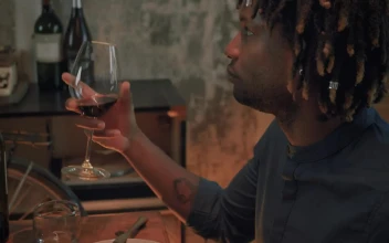 Stock Video Man Drinking From His Glass Of Wine On A Romantic Animated Wallpaper