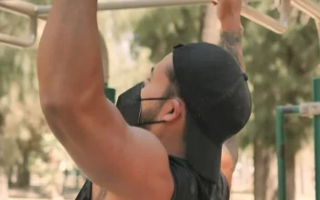 Stock Video Man Doing Pull Ups Wearing Face Mask Animated Wallpaper