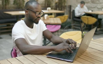 Stock Video Man Doing Online Research In Outdoor Cafe Animated Wallpaper