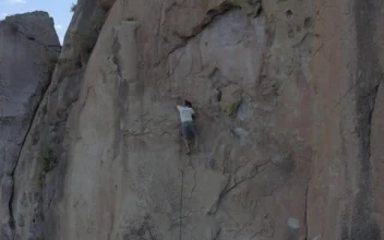 Stock Video Man Doing Mountaineering On A Large Rocky Mountain Smal Animated Wallpaper