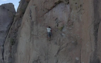 Stock Video Man Doing Mountaineering On A Large Rocky Mountain Animated Wallpaper
