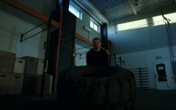 Stock Video Man Doing Crossfit Exercises With A Big Tire Animated Wallpaper