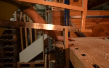 Stock Video Man Cutting A Wooden Board With A Large Lock Smal Animated Wallpaper
