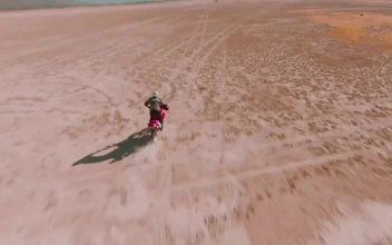 Stock Video Man Crossing The Desert On His Motorcycle Animated Wallpaper