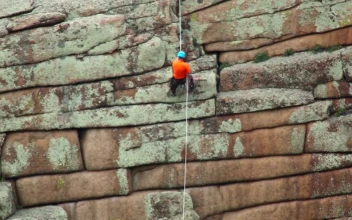 Stock Video Man Climbing Down A Rock Animated Wallpaper