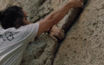 Stock Video Man Climbing A Rocky Mountain Animated Wallpaper