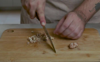 Stock Video Man Chopping Walnuts On A Wooden Board Animated Wallpaper