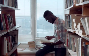 Stock Video Man Checking Books In The Library Animated Wallpaper