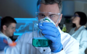 Stock Video Man Checking A Chemical Flask With Blue Liquid Animated Wallpaper
