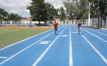Stock Video Man And Woman Training On A Running Track Animated Wallpaper