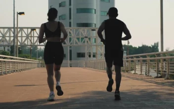 Stock Video Man And Woman Jogging Together On The Street Animated Wallpaper