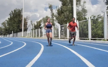 Stock Video Man And Woman Jogging On A Running Track Animated Wallpaper